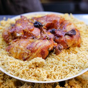 Close-up of a delicious chicken and rice meal served on a plate, perfect for food lovers.